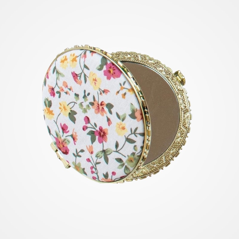 Miroir compact avec revêtement en tissu fleuri