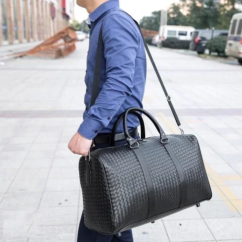 Détail des poignées renforcées du sac de voyage